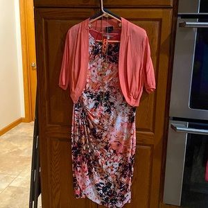 Sleeveless dress and shortsleeved sweater overlay with matching jewelry.